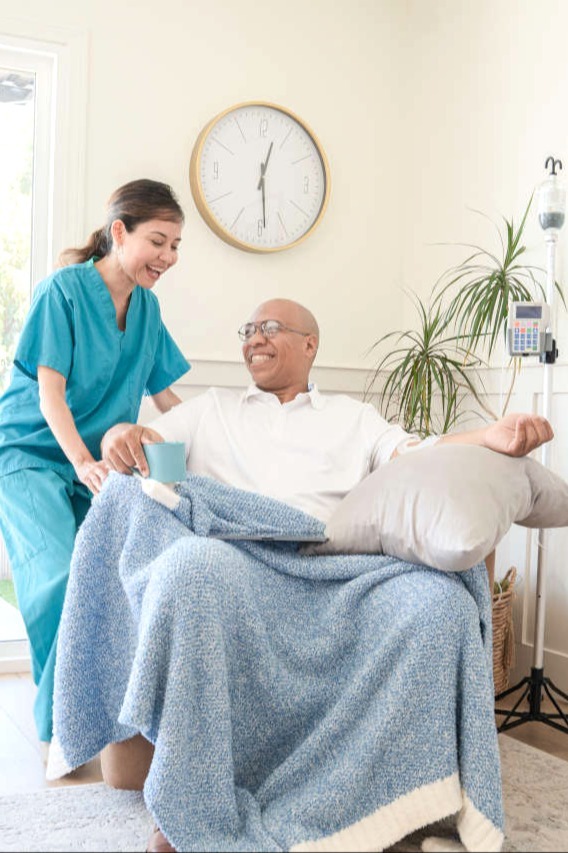 nurse and patient smiling together during an infusion treatment