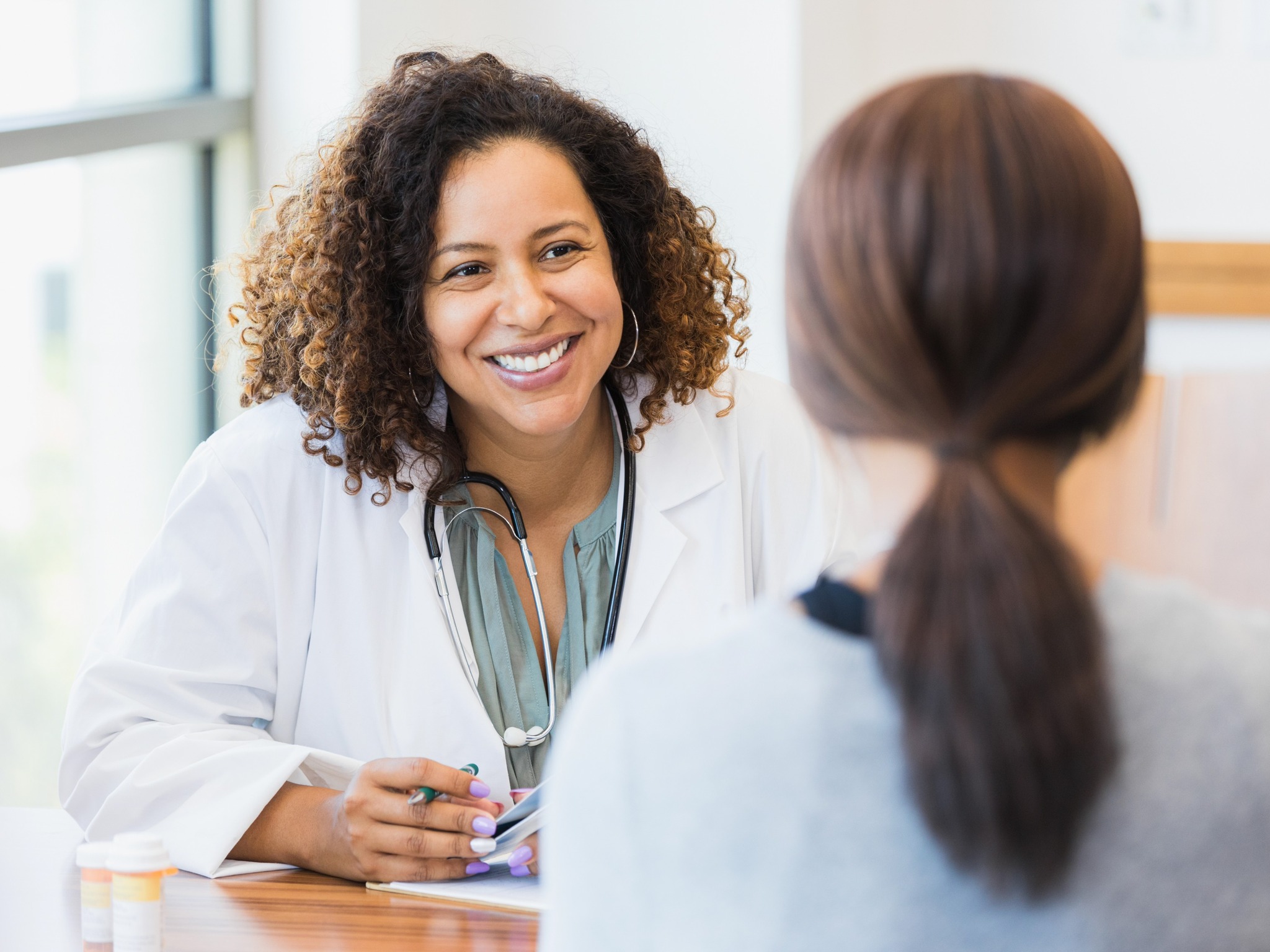 female doctor smiling during a consultation with a patient